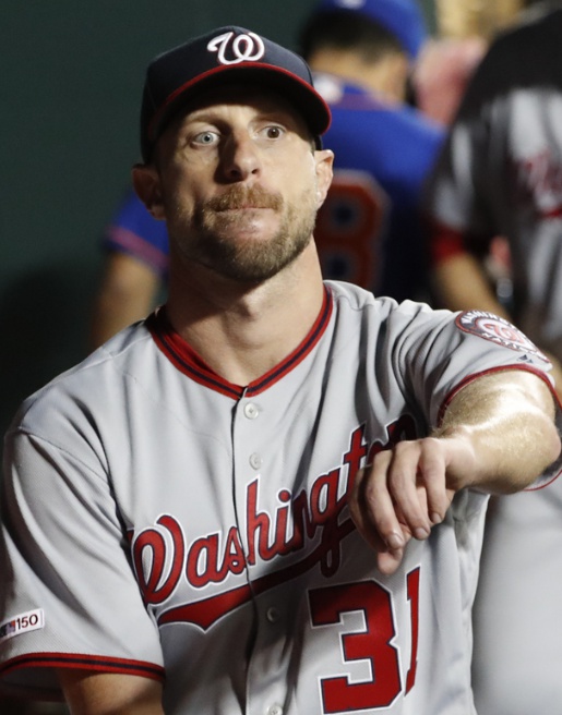 Washington Nationals starting pitcher Max Scherzer rests in the dugout after pitching six innings of the team's baseball game against the New York Mets in which he allowed six hits but no runs, Wednesday, May 22, 2019, in New York. (AP Photo/Kathy Willens)