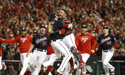 Washington Nationals' Yan Gomes and Daniel Hudson celebrate after Game 4 of the baseball National League Championship Series Tuesday, Oct. 15, 2019, in Washington. The Nationals won 7-4 to win the series 4-0. (AP Photo/Patrick Semansky)