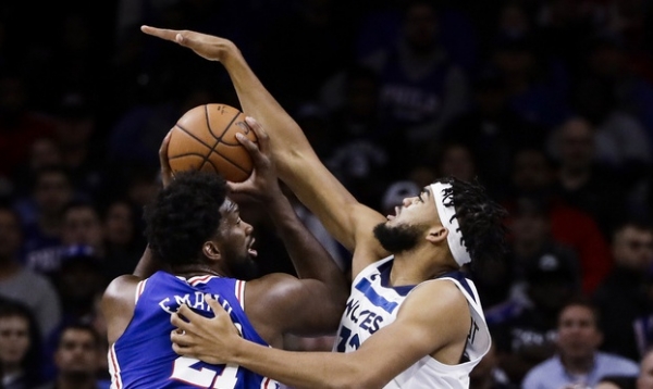 Philadelphia 76ers' Joel Embiid, left, looks for a shot as Minnesota Timberwolves' Karl-Anthony Towns defends during the first half of an NBA basketball game Wednesday, Oct. 30, 2019, in Philadelphia. The 76ers won 117-95. (AP Photo/Matt Rourke)