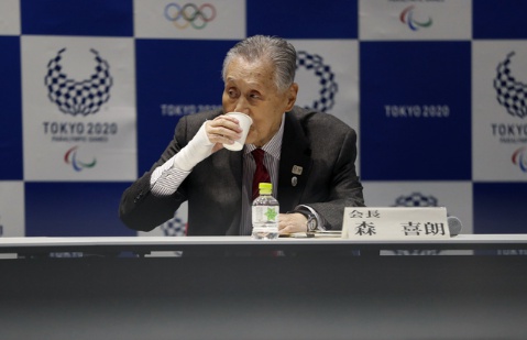 Tokyo 2020 Organizing Committee President Yoshiro Mori drinks a cup of water during the Tokyo 2020 Executive Board Meeting in Tokyo, Japan Monday, March 30, 2020. Mori said Monday he expects to talk with IOC President Thomas Bach this week about rescheduling the games for next year. (Issei Kato/Pool Photo via AP)